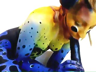 Pornography video with a sexy honey all frosted in paint and she is blowing a huge ebony dildo, rubbing it all over and touching her tits with it